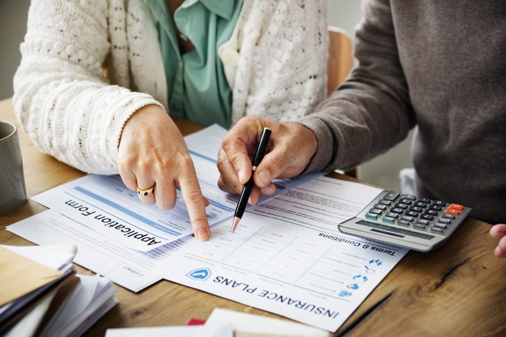 Two people filling out an application for insurance plans